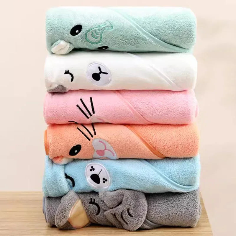 Stack of colorful baby and kids bath towels in green, white, pink, orange, blue, and gray with animal face designs