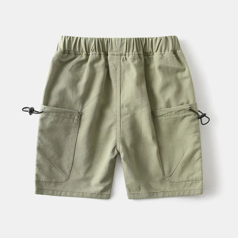 Back view of toddler wearing olive green boys cargo shorts with pockets and elastic waistband