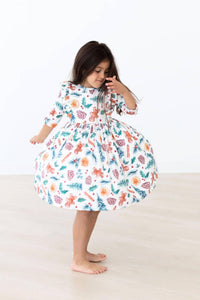 Girls white kids Christmas ruffle dress with colorful holiday print and 3/4 sleeves by Mila Rose