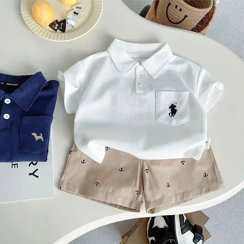 white polo shirt and beige anchor patterned shorts kids khaki shorts set for toddlers on table