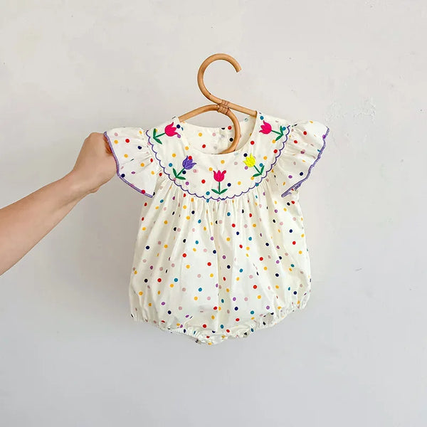 baby white polka dot romper with colorful floral embroidery and ruffled sleeves for infants
