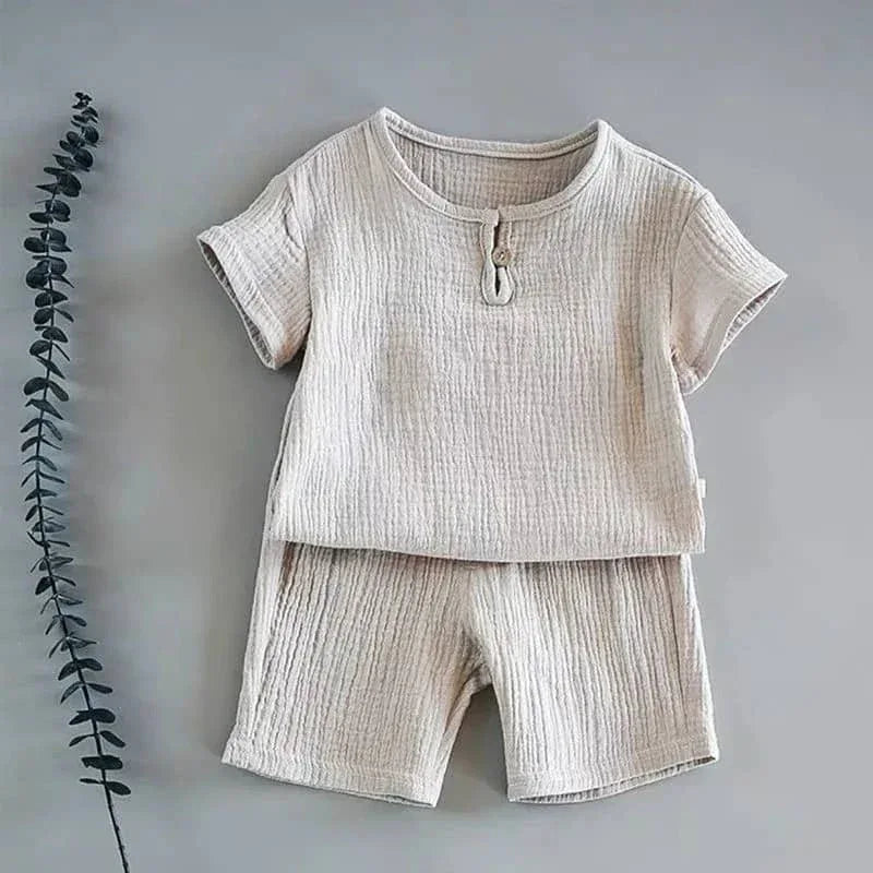 beige toddlers shorts set with short sleeve top and button detail made of textured fabric