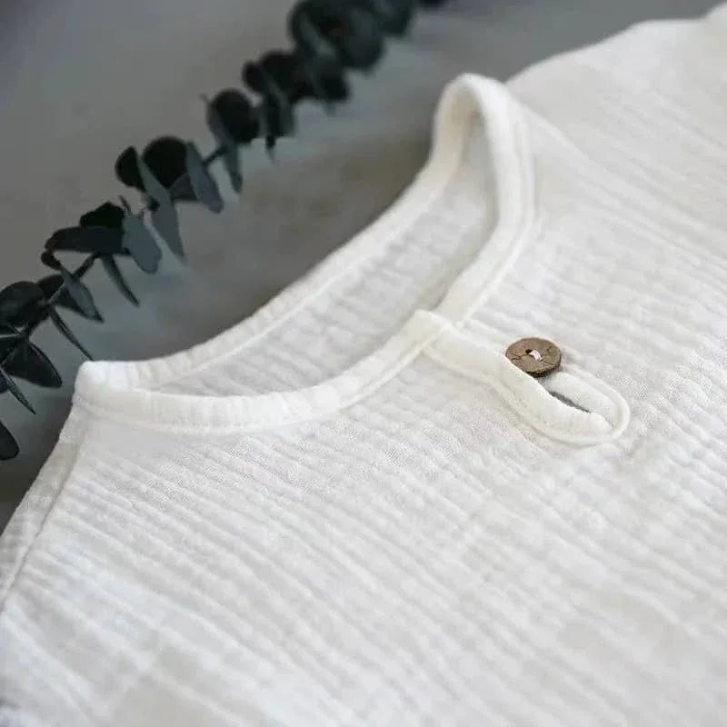 baby white textured cotton shorts set top with round neckline and wooden button detail