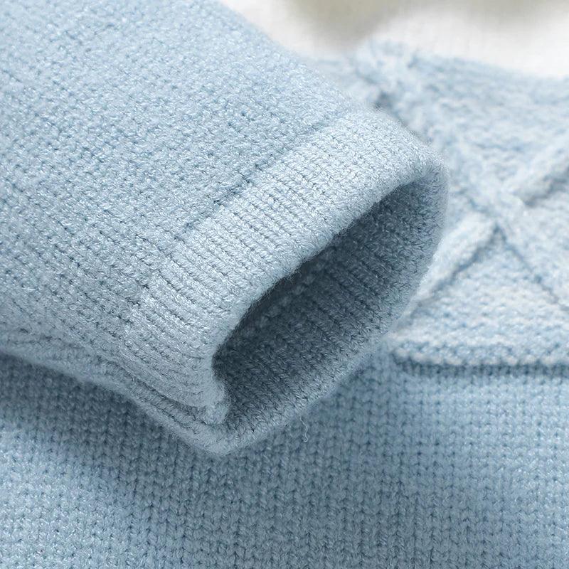Light blue knit footed romper for infants with soft ribbed cuff detail