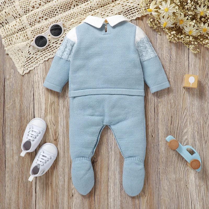 Light blue knit footed romper for infants with white collar and cable knit sleeves, newborn size
