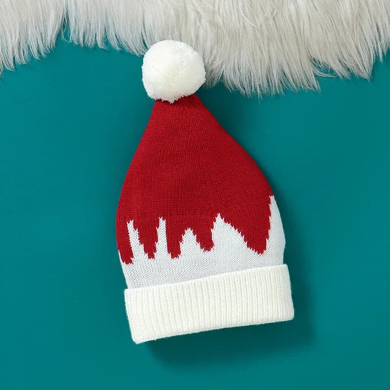 red and white knit baby hat with white pom pom and cuff