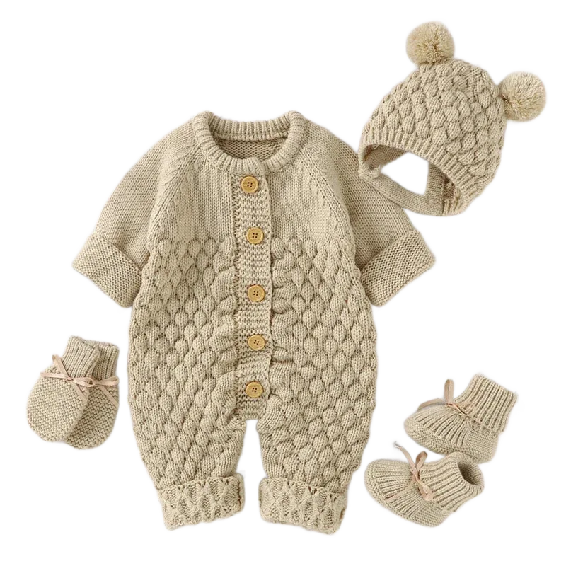 Beige knit romper set for babies with textured pattern, button front, matching hat with pom poms and booties