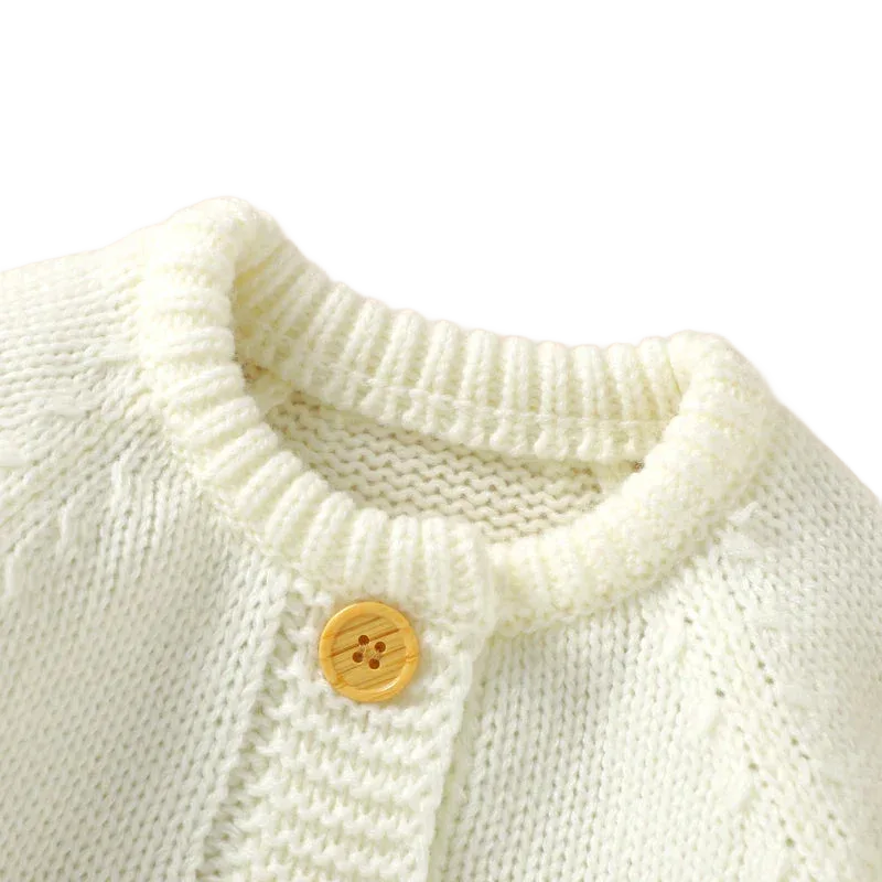 cream knit romper set for babies with wooden button detail on round neckline