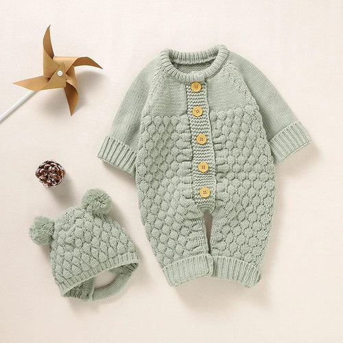 Baby green knit romper set with honeycomb pattern and yellow buttons with matching pom pom hat