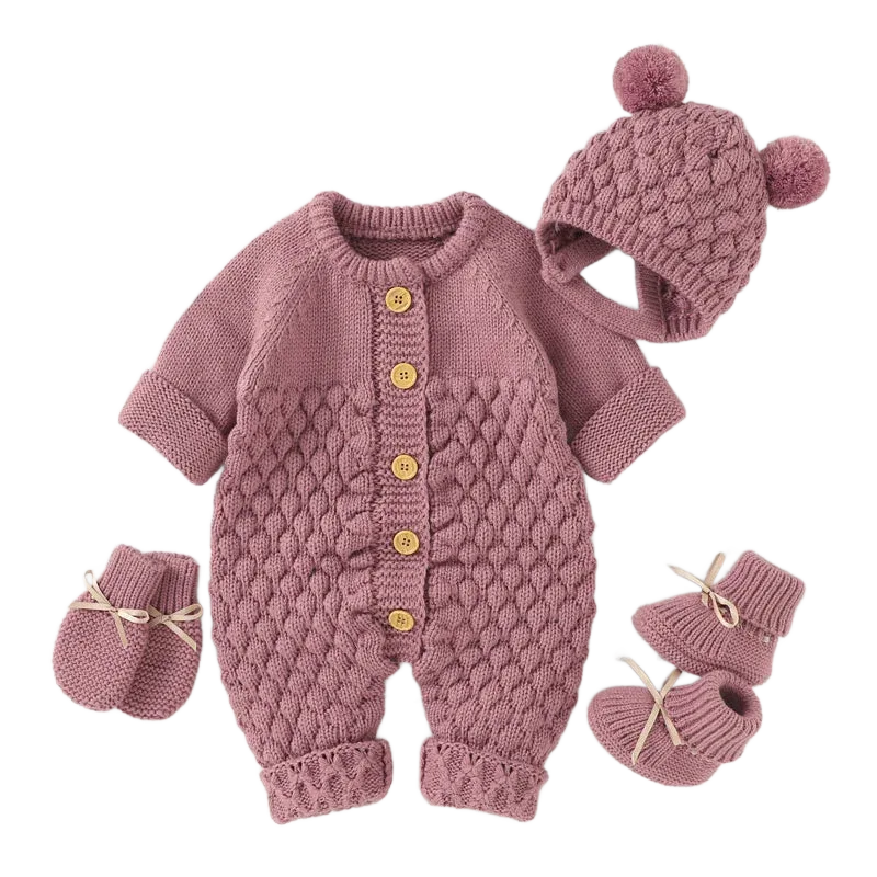 Baby knit romper set in dusty pink with textured pattern, wooden buttons, matching hat with pom poms and booties