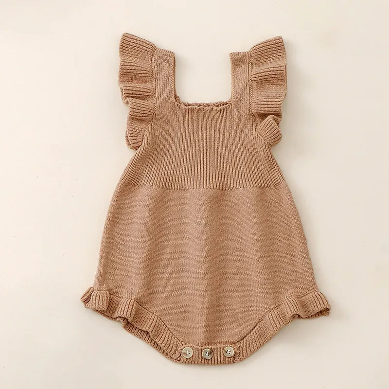 tan ruffle knit romper for babies with button closure and frilled shoulder straps