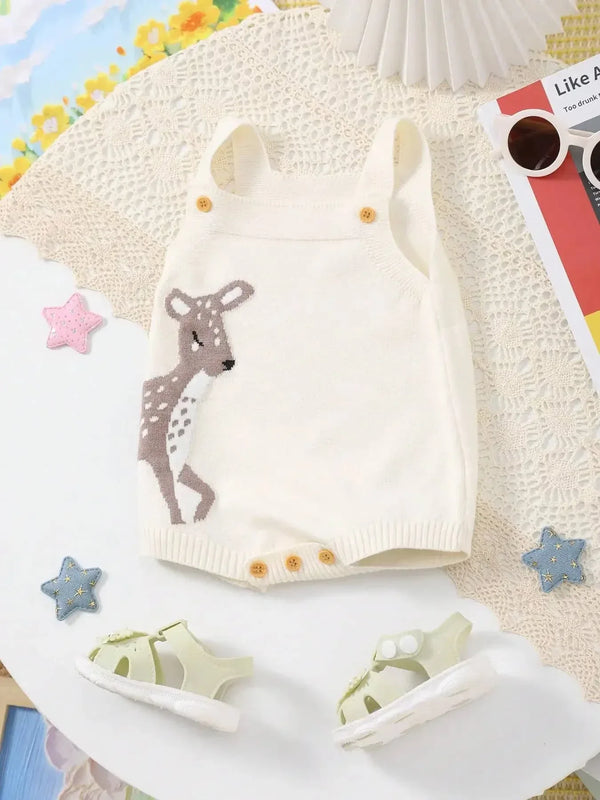 cream knitted baby bubble romper with deer design for infants laid flat with white baby sandals