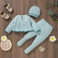 Light blue knitted baby outfit set with ruffle hem sweater, footed pants, and cable knit hat for infants