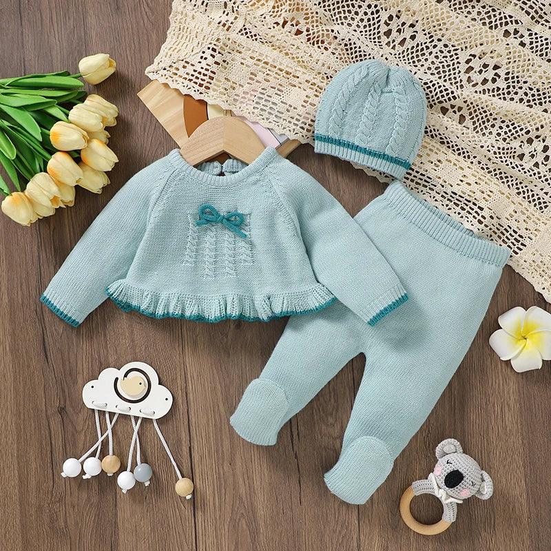 Light blue knitted baby outfit set for infants with bow detail and matching hat