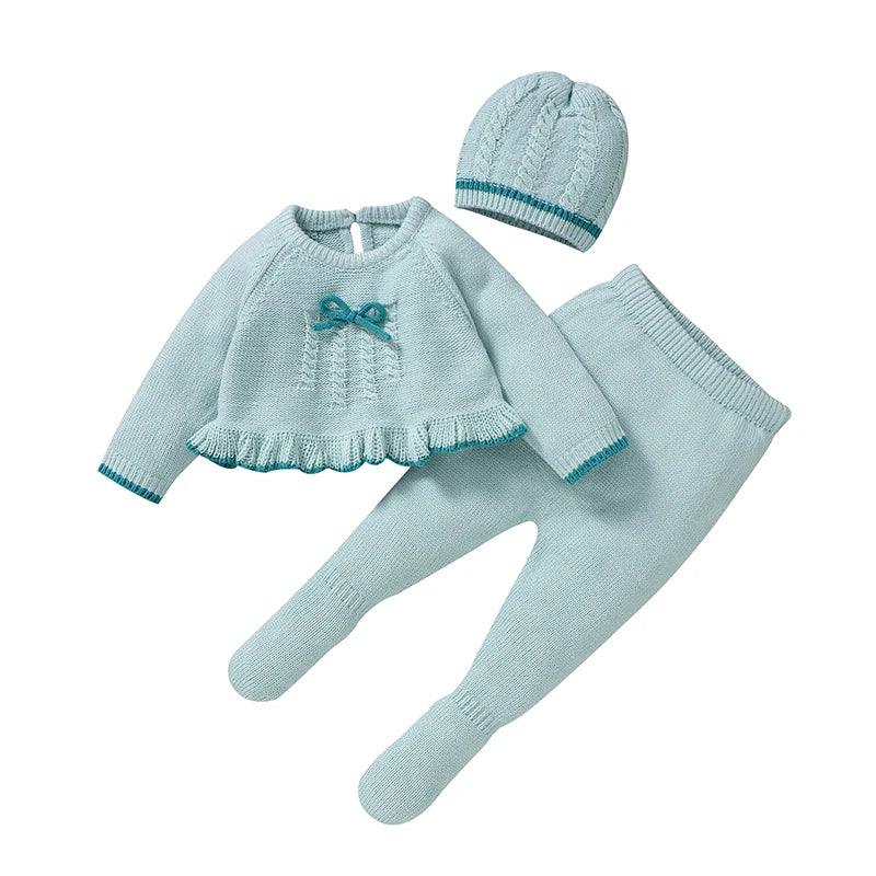 Light blue knitted baby outfit set for newborns with ruffle hem sweater, matching pants, and cable knit hat
