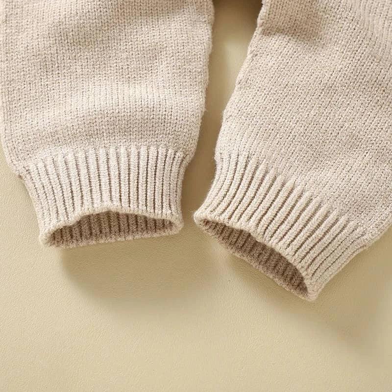 Close-up of beige knitted baby romper overalls sleeves suitable for infants and toddlers