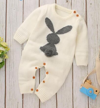 cream knitted baby romper with bunny design featuring gray bunny and pom pom tail for infants