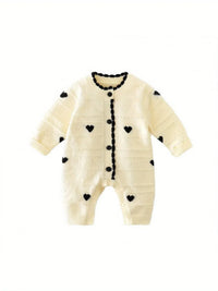 Cream knitted baby romper with hearts in black for infants with button front and long sleeves