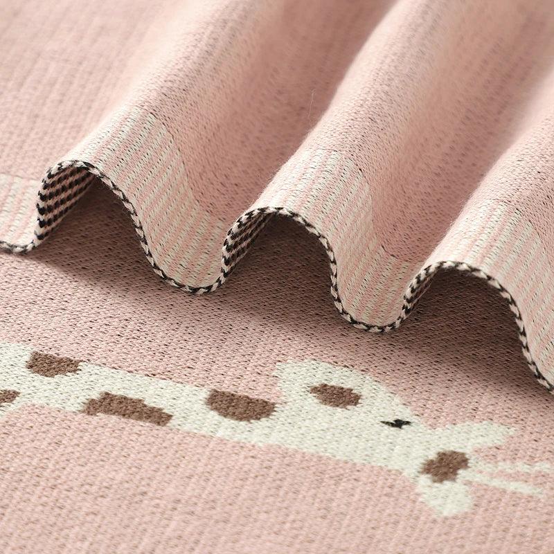 pink knitted giraffe baby blanket for infants with soft texture and cute giraffe design