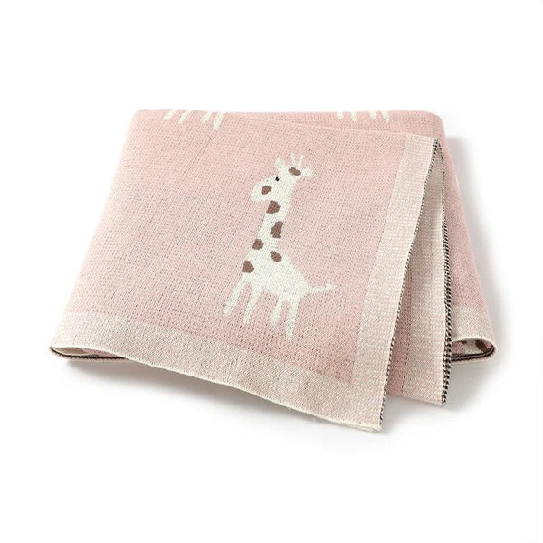 pink knitted giraffe baby blanket for babies with cute white and brown giraffe design