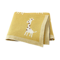 yellow knitted giraffe baby blanket for babies with white giraffe pattern and beige border