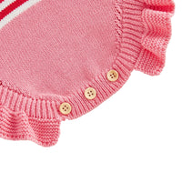 pink knitted newborn romper for baby with wooden buttons and ruffle trim detail
