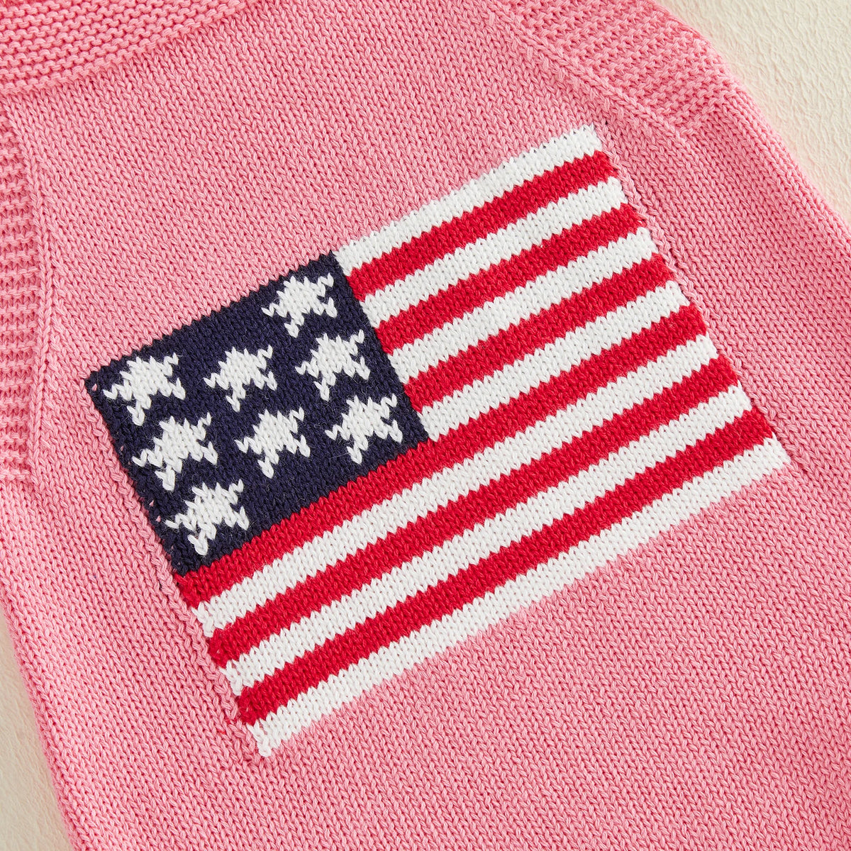pink knitted newborn romper with American flag design for baby