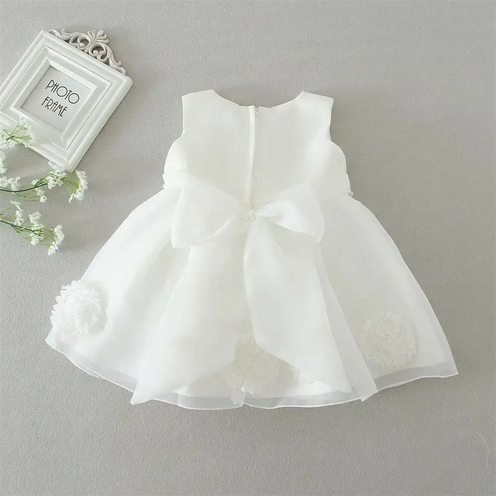White lace and tulle toddler dress with large bow back and floral accents for young girls