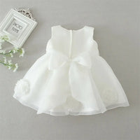 White lace and tulle toddler dress with large bow back and floral accents for young girls