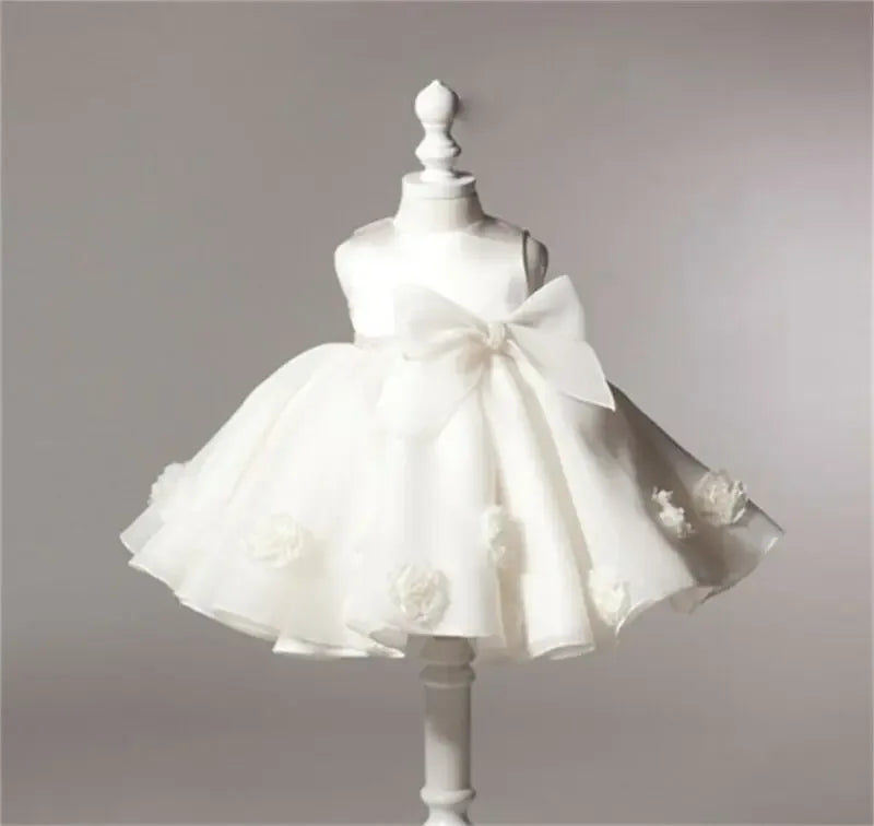 white lace and tulle toddler dress with large bow and flower details, sleeveless for toddlers