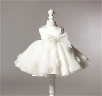 white lace and tulle toddler dress with large bow and flower details, sleeveless for toddlers
