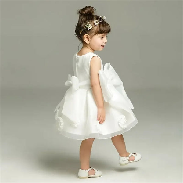 White lace and tulle toddler dress for girls with large bow detail and sleeveless design