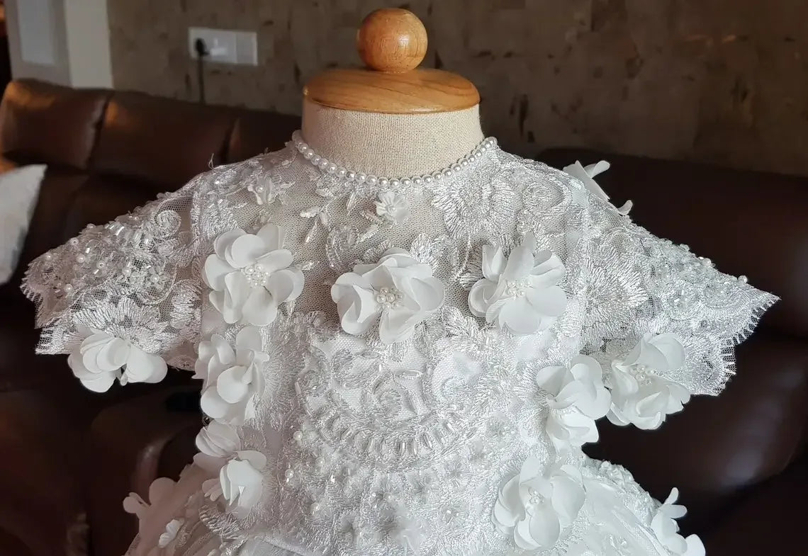 White lace baptism gown for babies with 3D floral appliques and pearl neckline detail