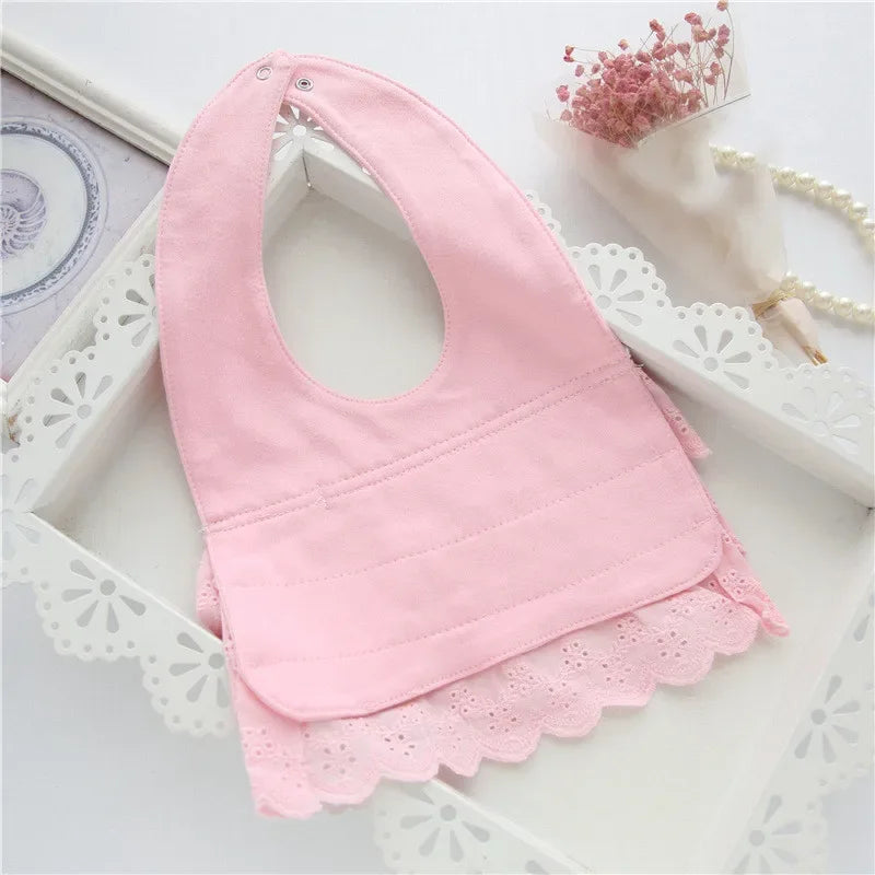 pink lace bib for babies laid flat with floral trim for infants and toddlers