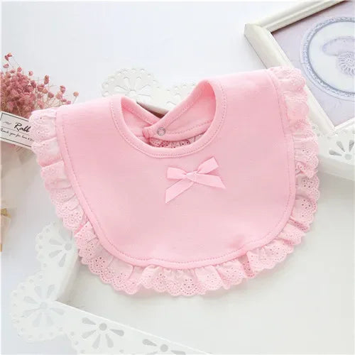 Pink lace bib for babies with bow detail designed for infants and toddlers