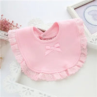 Pink lace bib for babies with bow detail designed for infants and toddlers
