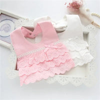 pink and white lace bib for babies with scalloped edges and bow detail for infant girls