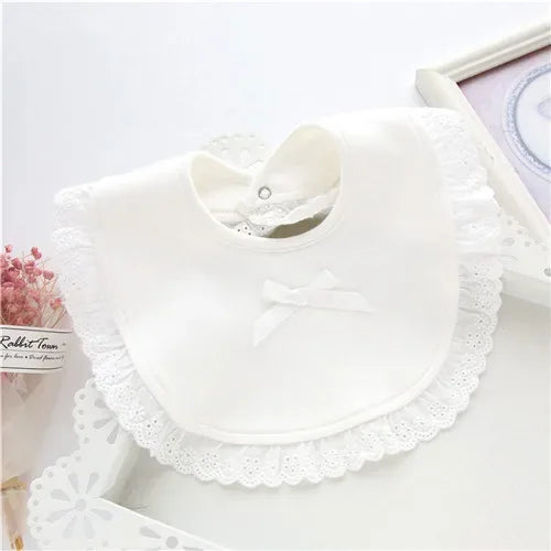 white lace bib for babies with scalloped edges and small bow for newborns and infants