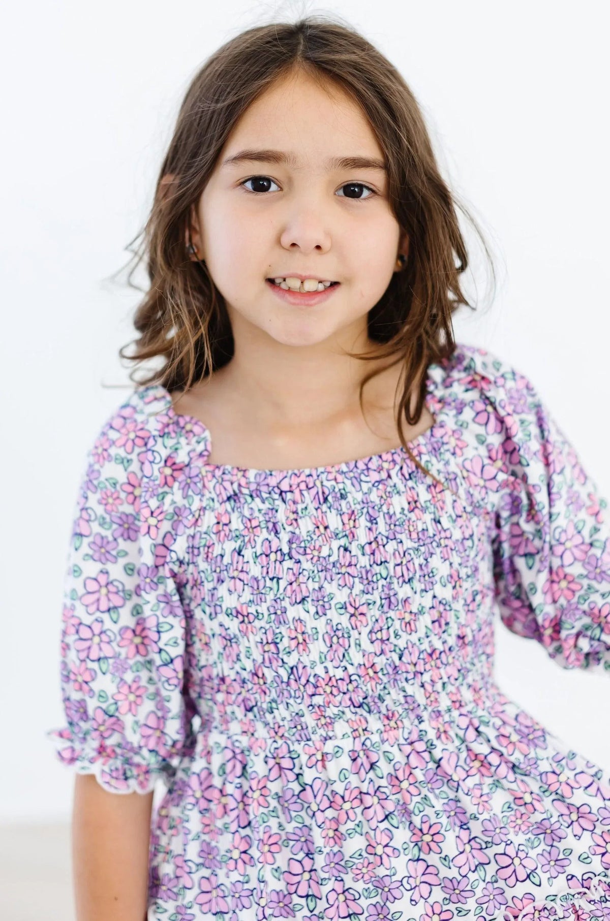 Lavender floral smocked dress for girls by Mila & Rose with ruffle detail and puff sleeves