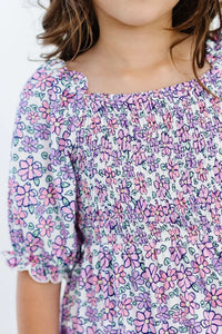 Girls lavender floral smocked dress for girls with ruffle detail and puff sleeves by Mila & Rose