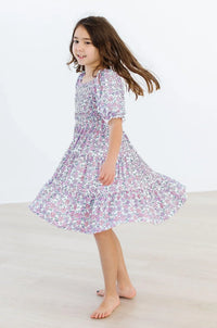 Girls lavender floral smocked dress for girls with ruffle sleeves and flowing skirt