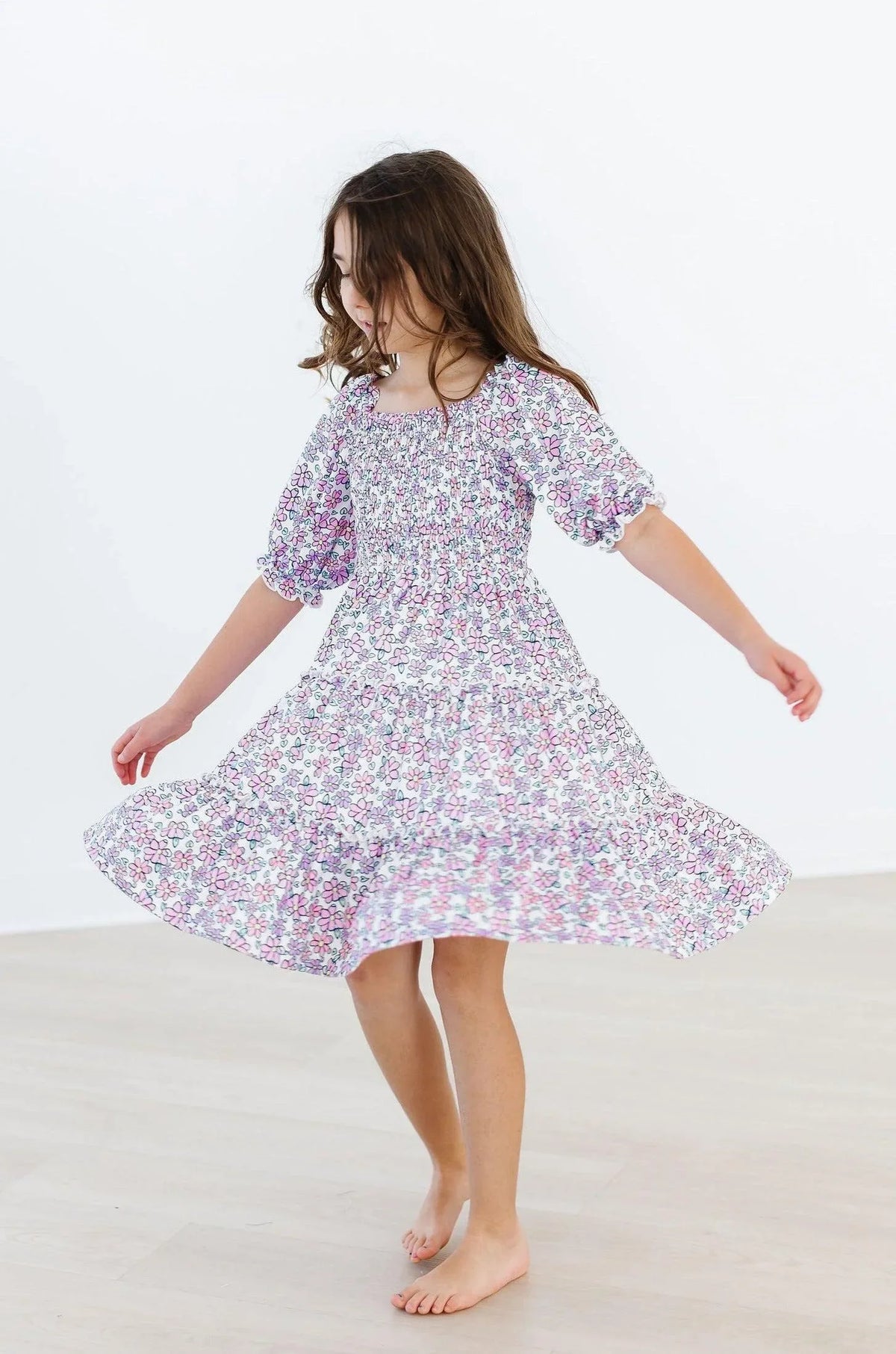 Lavender floral smocked dress for girls with puff sleeves and ruffled hem by Mila & Rose