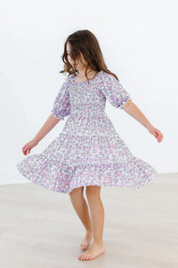 Lavender floral smocked dress for girls with puff sleeves and ruffled hem by Mila & Rose