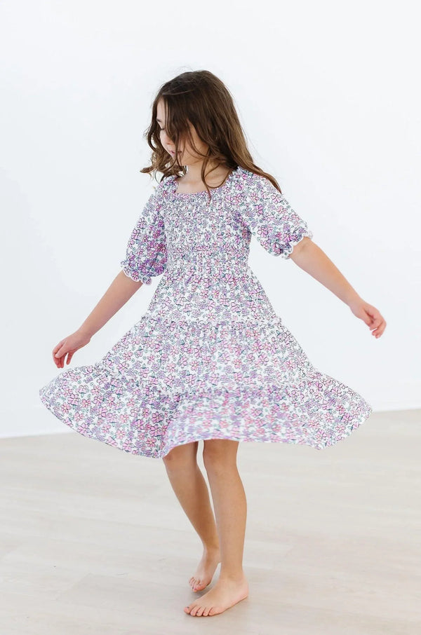 Lavender floral smocked dress for girls with puff sleeves and ruffled hem by Mila & Rose