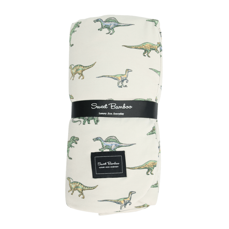 Legendary Cloud Blanket with dinosaur print on soft cream fabric; double-layer jersey, plush polyester lining.