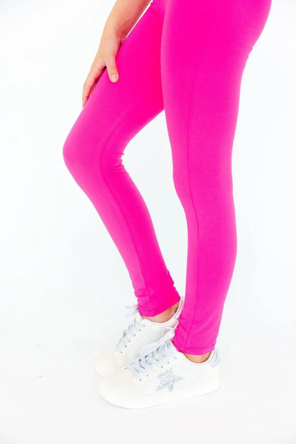 Child wearing bright pink Mila & Rose leggings standing with one hand on knee