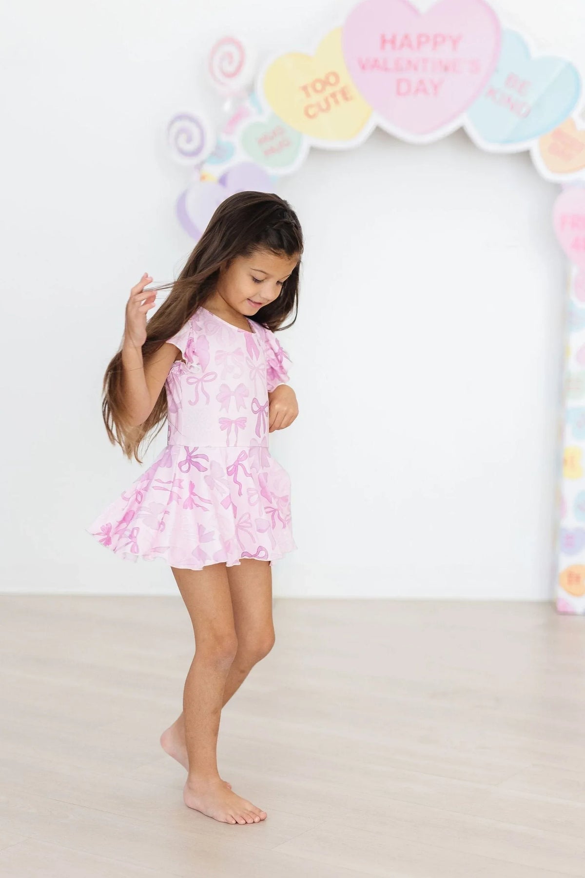 Girls pink short sleeve Twirl leotard by Mila & Rose with floral print and skirt detail