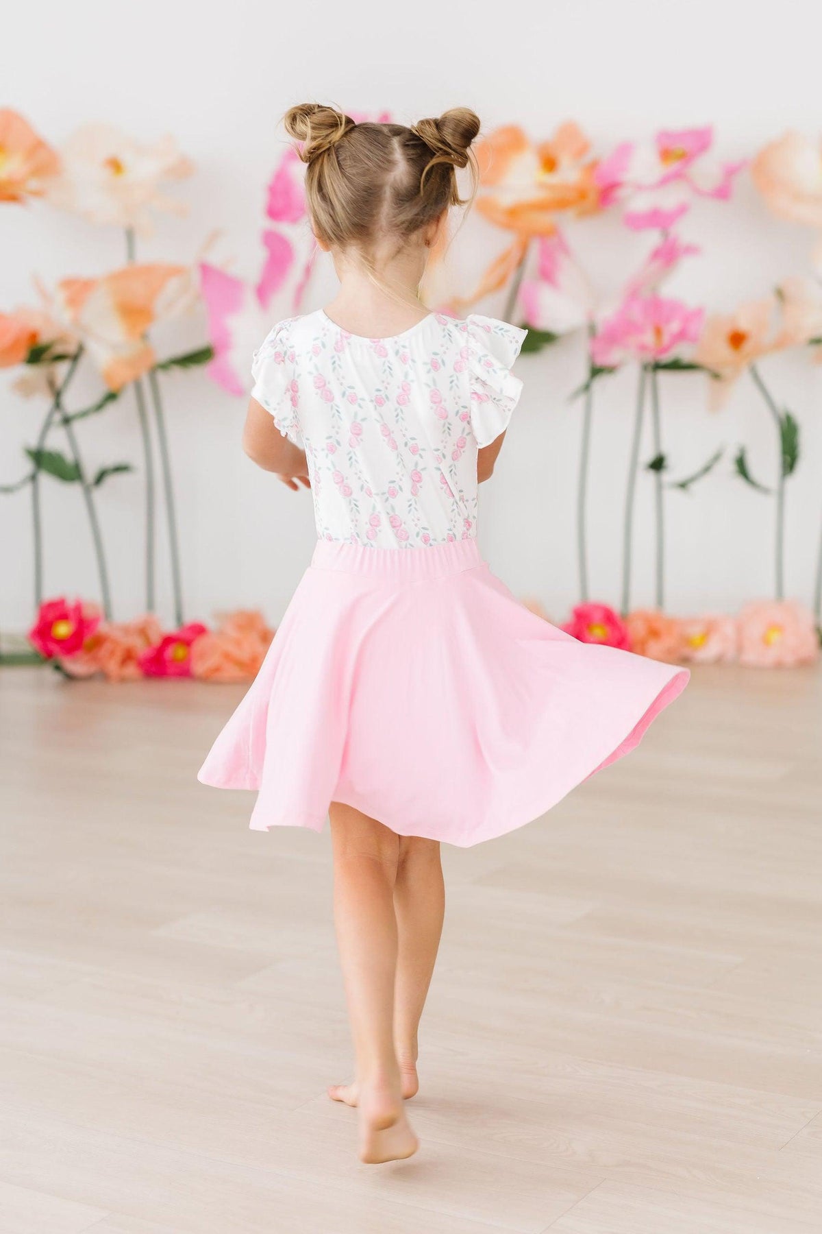Girls pink and white flutter leotard leotard with short sleeves and floral design by Mila & Rose