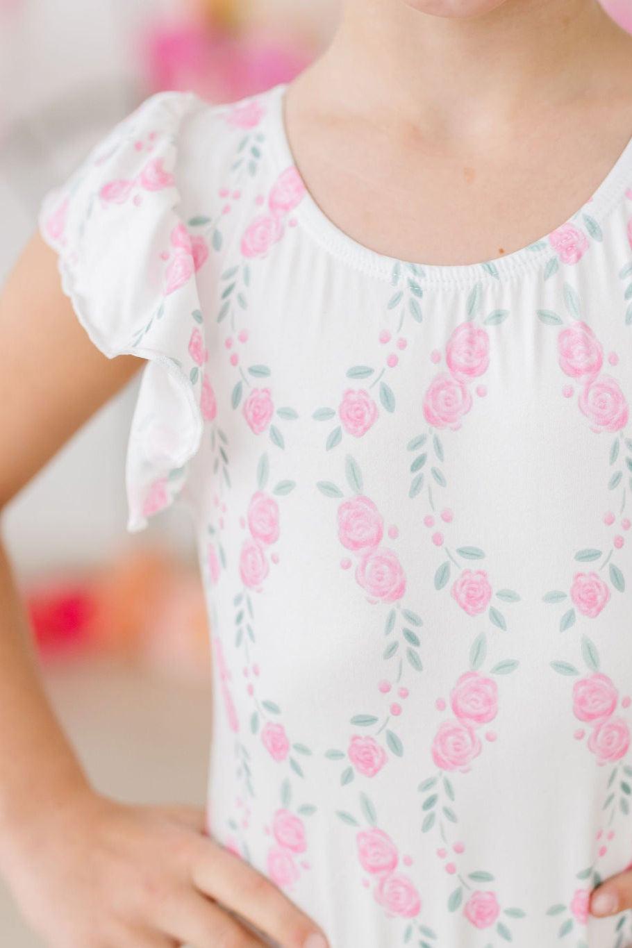 Girls white flutter leotard leotard with pink floral print and short sleeves sized for children