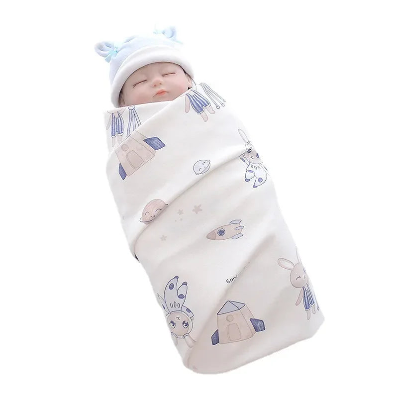 Lightweight cotton baby swaddle blanket in white with blue and beige animal and rocket prints for infants